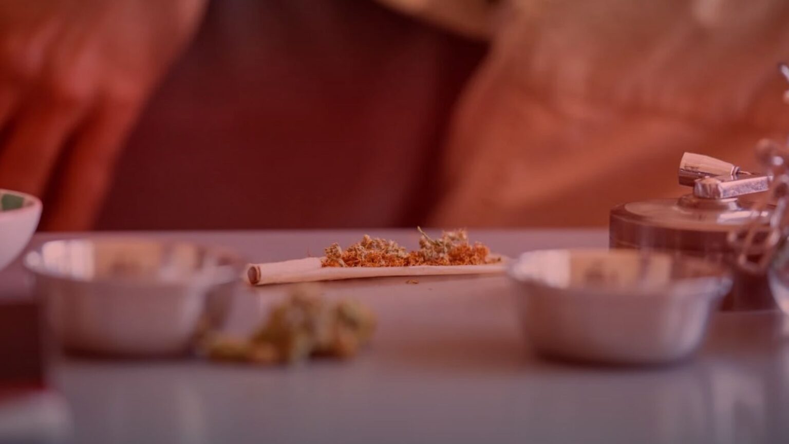 Nature's Canopy House A partially rolled cigarette on a table, surrounded by small bowls and a lighter. Dispensary In Mississauga