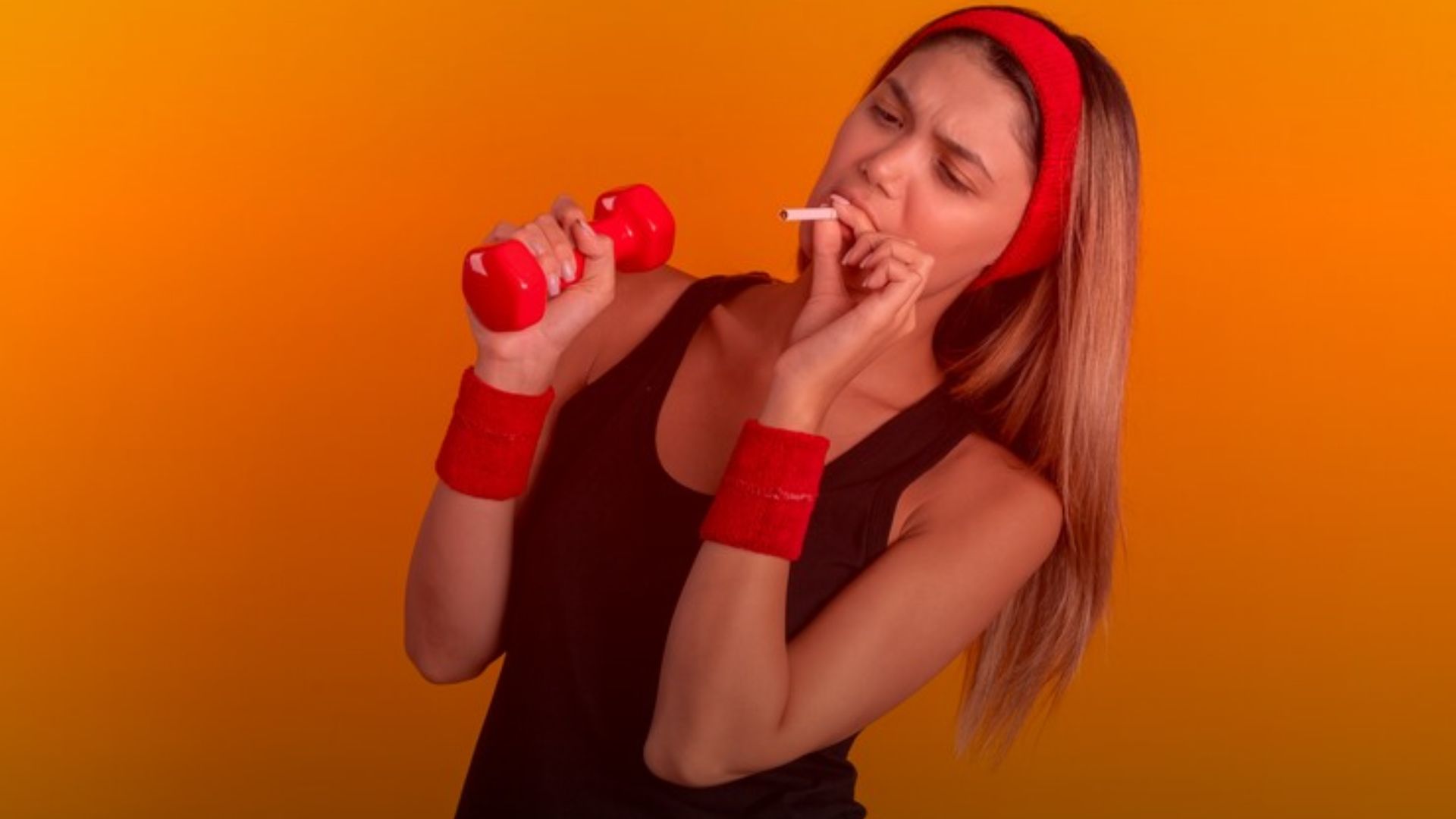 Nature's Canopy House A woman with long hair holds a red dumbbell in one hand and a lit cigarette—hinting at cannabis for workouts—in the other against an orange background. She wears a red headband and wristbands, embodying an unconventional blend of fitness and relaxation. Dispensary In Mississauga