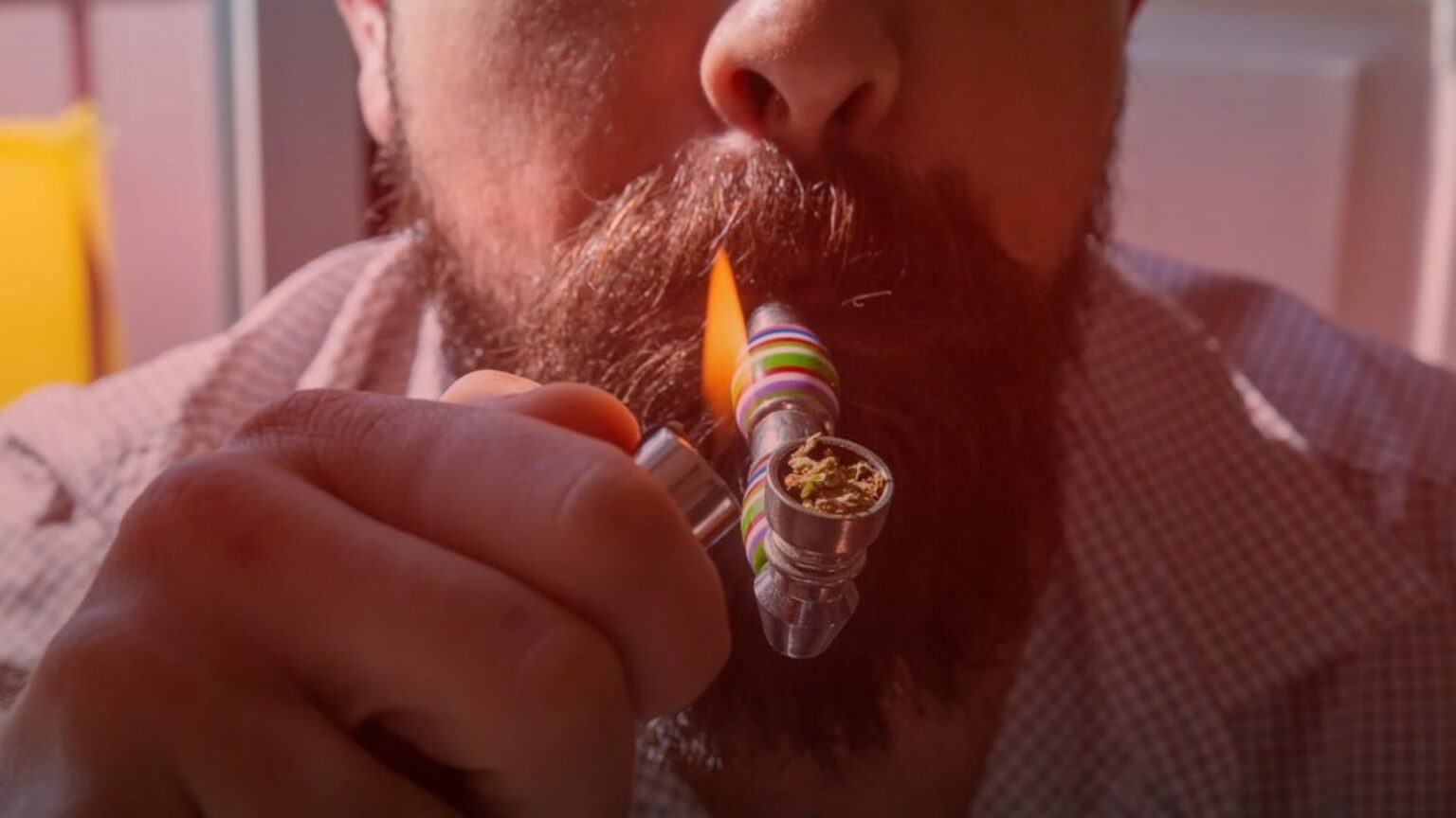 Nature's Canopy House A person lights a pipe with cannabis accessories, using a lighter to take a puff of the herbal substance. Dispensary In Mississauga