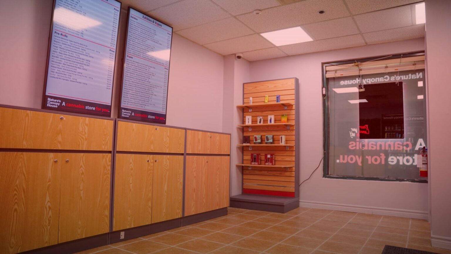 Nature's Canopy House Stepping into the store on your first cannabis visit, you'll find wooden display cabinets on the left and two digital menu screens above. A shelf showcasing an array of products stands invitingly in front of a window on the right, setting a welcoming tone for exploration. Dispensary In Mississauga